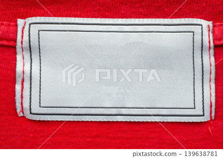 Blank white laundry care clothes label on red shirt fabric texture background 139638781