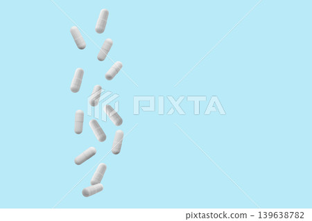 Falling white medicine pills capsule on blue background Falling white medicine pills capsule on blue background 139638782