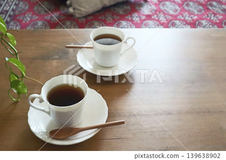 Tea time for two: a wooden table and coffee Tea time for two: a wooden table and coffee 139638902