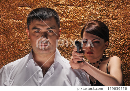 woman with gun protecting her man woman with gun protecting her man 139639356
