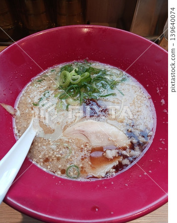 Soy sauce ramen served in a red bowl with plenty of condiments. Soy sauce ramen served in a red bowl with plenty of condiments. 139640074