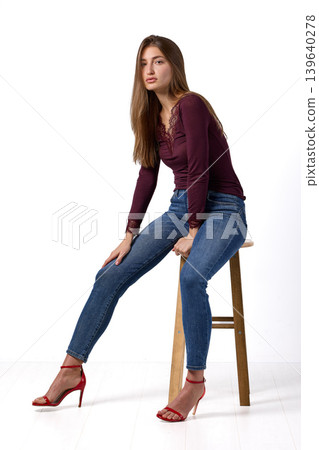 Slavic fashion model seated in studio portrait 139640278