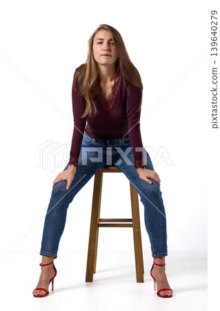 Slavic fashion model seated in studio portrait Slavic fashion model seated in studio portrait 139640279
