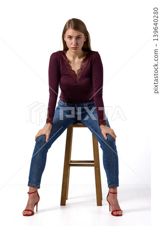 Slavic fashion model seated in studio portrait Slavic fashion model seated in studio portrait 139640280