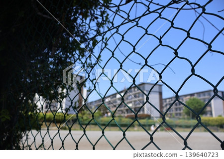 Apartment complex beyond the fence Apartment complex beyond the fence 139640723