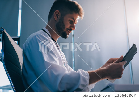 Man, doctor and laptop typing in healthcare research, communication or social media at office desk. Male medical expert working on computer in online search, browsing or chatting on tablet at clinic Man, doctor and laptop typing in healthcare research, communication or social media at office desk. Male medical expert working on computer in online search, browsing or chatting on tablet at clinic 139640807