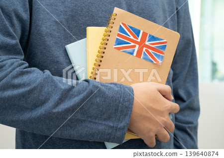 Learn English language, Asian teenage student hold book with flag in course at school. Learn English language, Asian teenage student hold book with flag in course at school. 139640874