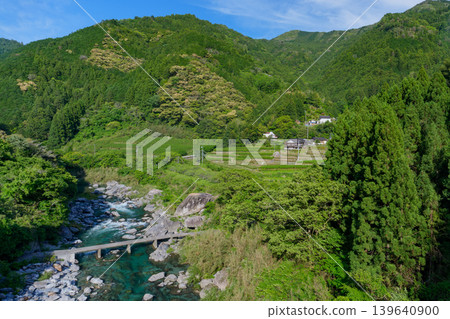A long, low-water bridge spanning the Doi River, a tributary of the Niyodo River, in the pristine river scenery of Kochi Prefecture. A long, low-water bridge spanning the Doi River, a tributary of the Niyodo River, in the pristine river scenery of Kochi Prefecture. 139640900