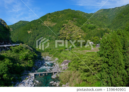 A long, low-water bridge spanning the Doi River, a tributary of the Niyodo River, in the pristine river scenery of Kochi Prefecture. A long, low-water bridge spanning the Doi River, a tributary of the Niyodo River, in the pristine river scenery of Kochi Prefecture. 139640901