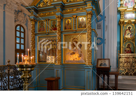 Orthodox Church Iconostasis With Virgin and Child Icon, Gold Detailing and Lit Candles in Blue Interior Orthodox Church Iconostasis With Virgin and Child Icon, Gold Detailing and Lit Candles in Blue Interior 139642151