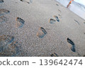 Footprints left on the sandy beach | Images of summer memories walking along the seaside 139642474