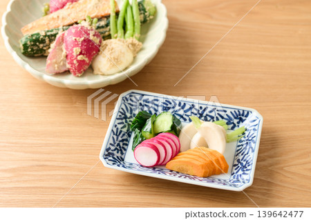Pickled cucumbers, turnips, carrots, and radishes in rice bran 139642477