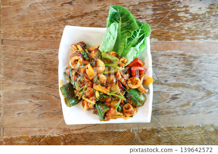 stir fried squid or stir fried spicy squid with sweet pepper and onion or spicy squid stir fried squid or stir fried spicy squid with sweet pepper and onion or spicy squid 139642572