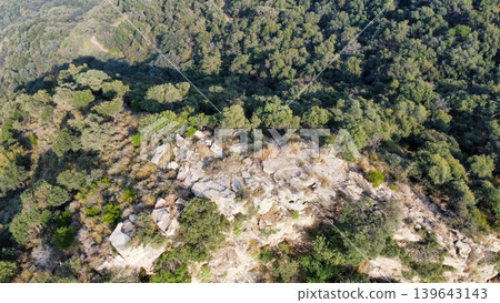 Rocky mountain ridge surrounded by forest at Tilla Jogian Pakistan Rocky mountain ridge surrounded by forest at Tilla Jogian Pakistan 139643143