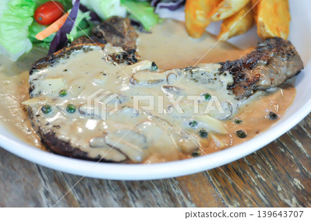 pork steak or grilled pork and salad or pork chop with fried potato and vegetable pork steak or grilled pork and salad or pork chop with fried potato and vegetable 139643707