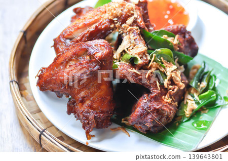 fried chick with fried garlic or chicken wings or deep fried chicken , fried chicken and sauce 139643801