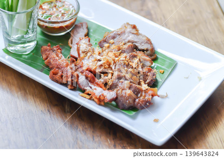 fried pork with fried garlic , fried pork or sliced pork with dip or chili sauce 139643824