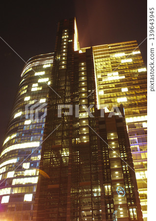 skyscraper skyscraper tall building at night illuminated with office lights skyscraper skyscraper tall building at night illuminated with office lights 139643945