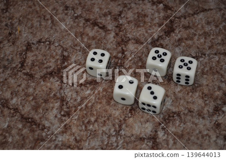 white dice playing on the brown carpet white dice playing on the brown carpet 139644013