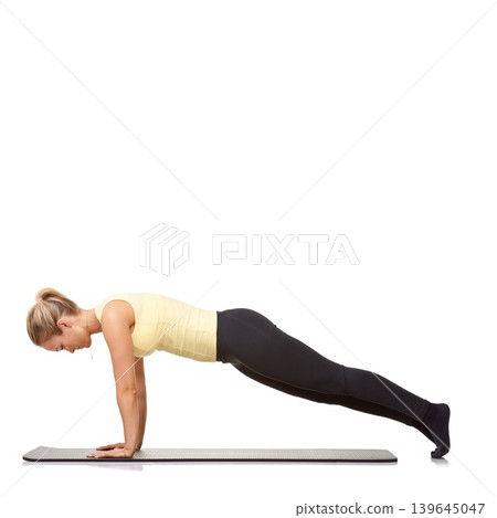 Woman, push up and fitness in studio for exercise, workout and stretching body on mockup white background. Profile of healthy lady balance on a mat for strong core, training and challenge on floor Woman, push up and fitness in studio for exercise, workout and stretching body on mockup white background. Profile of healthy lady balance on a mat for strong core, training and challenge on floor 139645047