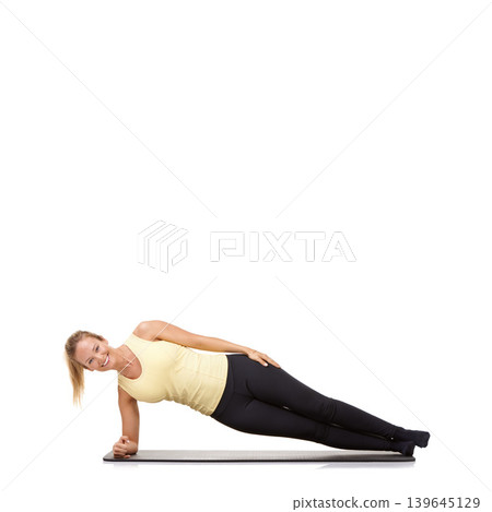 Woman, yoga and mat in studio with side plank, fitness or workout for healthy body, happy or core muscle. Person, portrait and pilates on floor for abdomen health on mockup space or white background Woman, yoga and mat in studio with side plank, fitness or workout for healthy body, happy or core muscle. Person, portrait and pilates on floor for abdomen health on mockup space or white background 139645129