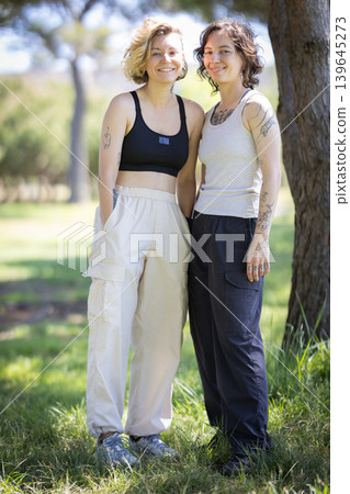 Smiling young women enjoying outdoor park lifestyle Smiling young women enjoying outdoor park lifestyle 139645273