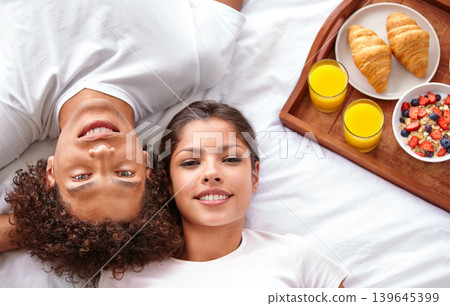 Couple, portrait and breakfast in bed for bonding, healthy meal and celebrating anniversary at home. People, marriage milestone and love or loyalty in relationship, romance and food for nutrition 139645399