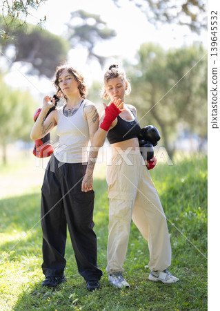 Young women boxers posing after training outdoors Young women boxers posing after training outdoors 139645532
