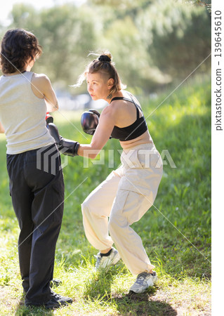 Women boxing training outdoors in a park Women boxing training outdoors in a park 139645610