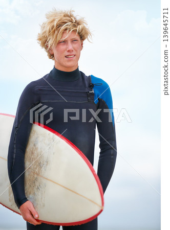 Surfer, teen boy on beach and surfboard, holiday and adventure for fitness and travel outdoor. Summer, athlete and surfing on seaside vacation in Hawaii, nature and tourism with extreme sports Surfer, teen boy on beach and surfboard, holiday and adventure for fitness and travel outdoor. Summer, athlete and surfing on seaside vacation in Hawaii, nature and tourism with extreme sports 139645711