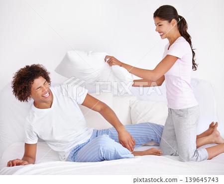Man, woman and pillow fight for bed game on morning holiday for love connection, funny or vacation. Happy partnership, cushion and pajamas or laughing in home for play couple comedy, joy or smile Man, woman and pillow fight for bed game on morning holiday for love connection, funny or vacation. Happy partnership, cushion and pajamas or laughing in home for play couple comedy, joy or smile 139645743