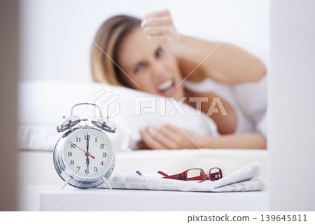 Sleeping, anger and woman in bed with alarm for snooze, wake up and morning routine in home. Lazy, tired and person frustrated, angry and upset in bedroom for time, clock and ringing in apartment Sleeping, anger and woman in bed with alarm for snooze, wake up and morning routine in home. Lazy, tired and person frustrated, angry and upset in bedroom for time, clock and ringing in apartment 139645811