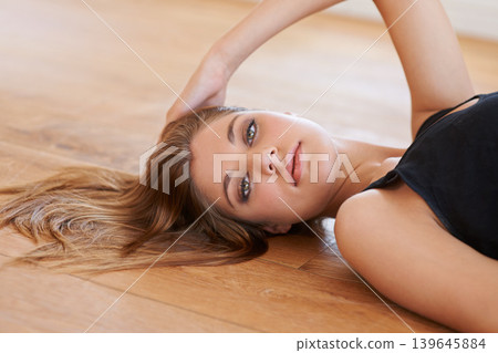 Portrait, natural beauty and woman on wooden floor in home to relax alone in Switzerland. Face, person and young girl lying in house, apartment or lounge with healthy skin, aesthetic and serious Portrait, natural beauty and woman on wooden floor in home to relax alone in Switzerland. Face, person and young girl lying in house, apartment or lounge with healthy skin, aesthetic and serious 139645884