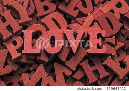 Inscription love on pile of old red vintage wooden letters. Inscription love on pile of old red vintage wooden letters. 139645912