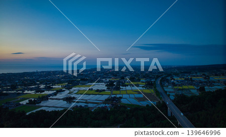 View of the area around Toyama Bay from the hills in the evening. 139646996