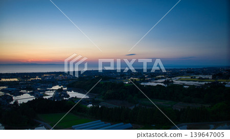 View of the area around Toyama Bay from the hills in the evening. View of the area around Toyama Bay from the hills in the evening. 139647005