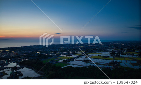 View of the area around Toyama Bay from the hills in the evening. View of the area around Toyama Bay from the hills in the evening. 139647024