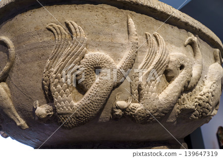 Abu Dhabi, United Arab Emirates - Jan 17 2024, close-up view from below of a marble bowl with the carved name of Bonifilius and the image of wild animals, on exhibition of Museum Louvre Abu Dhabi, UA Abu Dhabi, United Arab Emirates - Jan 17 2024, close-up view from below of a marble bowl with the carved name of Bonifilius and the image of wild animals, on exhibition of Museum Louvre Abu Dhabi, UA 139647319