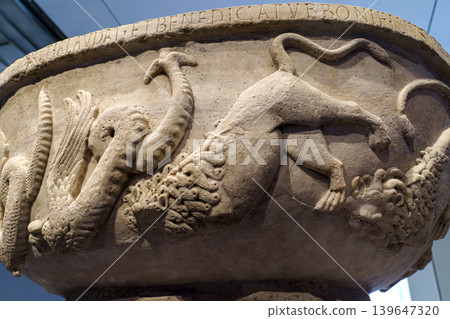 Abu Dhabi, United Arab Emirates - Jan 17 2024, close-up view from below of a marble bowl with the carved name of Bonifilius and the image of wild animals, on exhibition of Museum Louvre Abu Dhabi, UAE Abu Dhabi, United Arab Emirates - Jan 17 2024, close-up view from below of a marble bowl with the carved name of Bonifilius and the image of wild animals, on exhibition of Museum Louvre Abu Dhabi, UAE 139647320