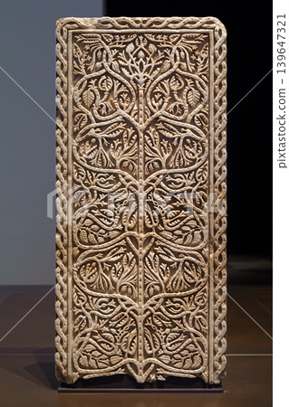 Abu Dhabi, United Arab Emirates - Jan 17 2024, close-up view of a marble carved architectural panel depicting the tree of life, on exhibition of museum Louvre Abu Dhabi, UAE 139647321