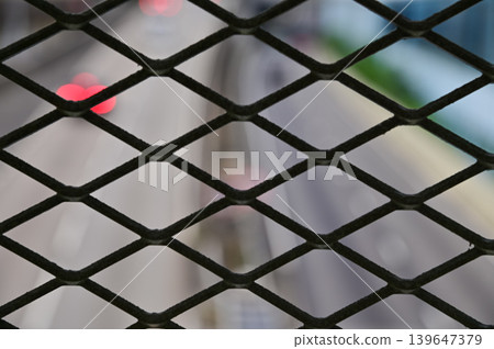 The view of Hong Kong cityscape, Looking from chain link fence. Street scene, modern city. Hong Kong city. Travel and city concept. The view of Hong Kong cityscape, Looking from chain link fence. Street scene, modern city. Hong Kong city. Travel and city concept. 139647379