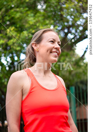 Smiling mature woman enjoying outdoor fitness activity in park Smiling mature woman enjoying outdoor fitness activity in park 139647452