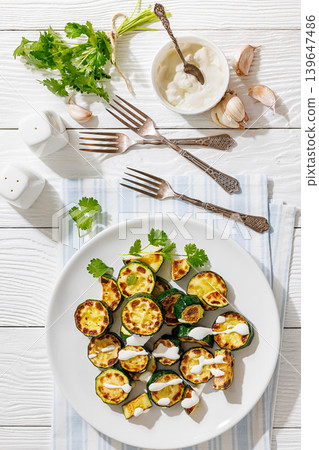 Fried zucchini with garlic yogurt sauce on plate Fried zucchini with garlic yogurt sauce on plate 139647486