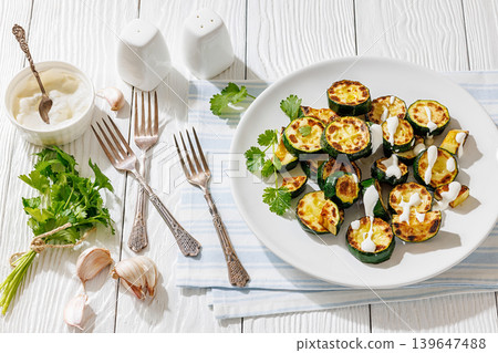 Fried zucchini with garlic yogurt sauce on plate Fried zucchini with garlic yogurt sauce on plate 139647488