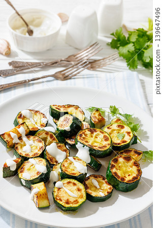 Fried zucchini with garlic yogurt sauce on plate Fried zucchini with garlic yogurt sauce on plate 139647496