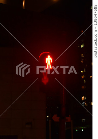 Pedestrian don't walk signal, Pedestrian signal with red light , Traffic lights and walk signs in Hong Kong at night. With blurred buildings background. Hong Kong Cityscape. Pedestrian don't walk signal, Pedestrian signal with red light , Traffic lights and walk signs in Hong Kong at night. With blurred buildings background. Hong Kong Cityscape. 139647688