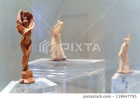 Abu Dhabi, United Arab Emirates - Jan 17 2024, close up view of the ancient statuettes of woman, at exhibition of the Louvre Abu Dhabi, UAE Abu Dhabi, United Arab Emirates - Jan 17 2024, close up view of the ancient statuettes of woman, at exhibition of the Louvre Abu Dhabi, UAE 139647795