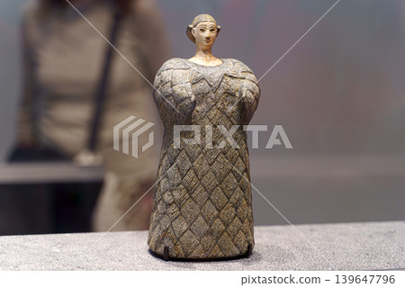 Abu Dhabi, United Arab Emirates - Jan 17 2024, close-up view of the exhibit, an ancient statuette of a woman in a wool dress, on exhibition of museum Louvre Abu Dhabi, UAE Abu Dhabi, United Arab Emirates - Jan 17 2024, close-up view of the exhibit, an ancient statuette of a woman in a wool dress, on exhibition of museum Louvre Abu Dhabi, UAE 139647796