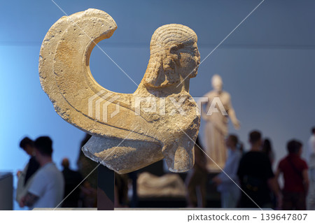 Abu Dhabi, United Arab Emirates - Jan 17 2024, Close-up view of the statue of the Sphinx, people walking in background, an exhibit of the Louvre Abu Dhabi Museum, Abu Dhabi, United Arab Emirates Abu Dhabi, United Arab Emirates - Jan 17 2024, Close-up view of the statue of the Sphinx, people walking in background, an exhibit of the Louvre Abu Dhabi Museum, Abu Dhabi, United Arab Emirates 139647807
