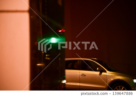 A car is going out of the carpark at night. Hong Kong Cityscape. A car is going out of the carpark at night. Hong Kong Cityscape. 139647886